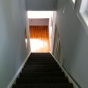 Looking down the stairs from the loft to the second floor