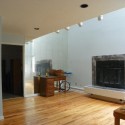 First floor great room with mirrored wall and busted fireplace